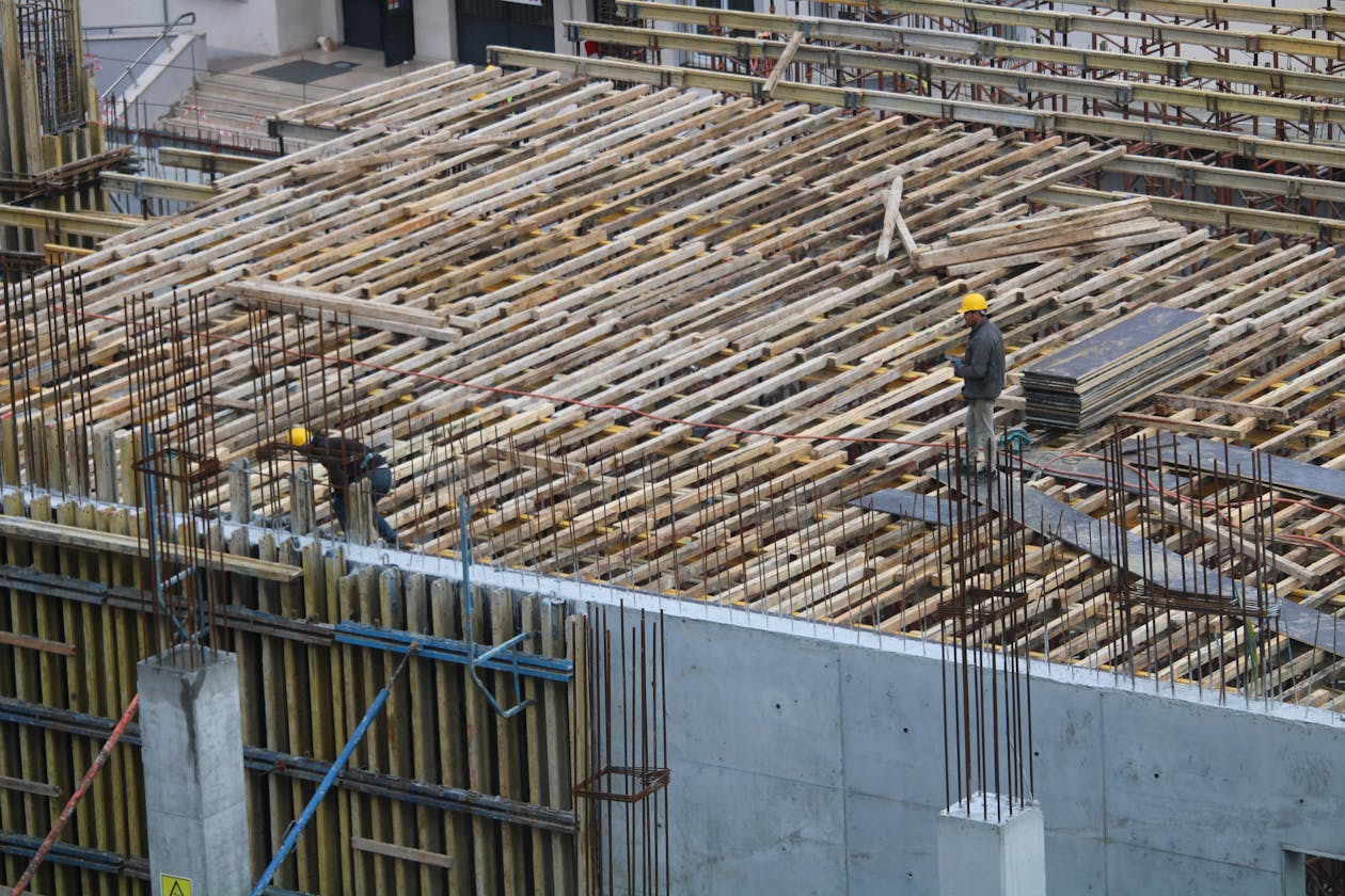 Men working on a construction site in Istanbul, with visible rebar and reinforcement structures. — concrete epoxy coating Omaha