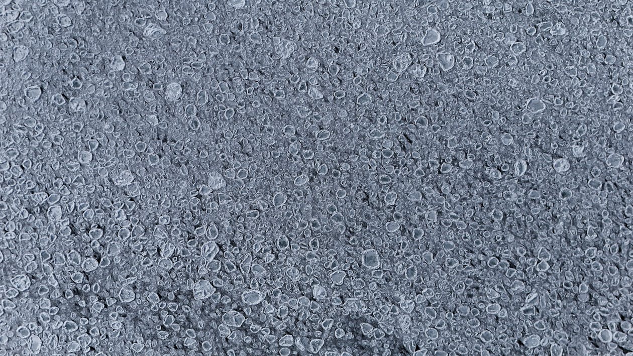 Detailed view of frozen bubbles on an icy surface capturing winter textures. — patio epoxy coating Omaha